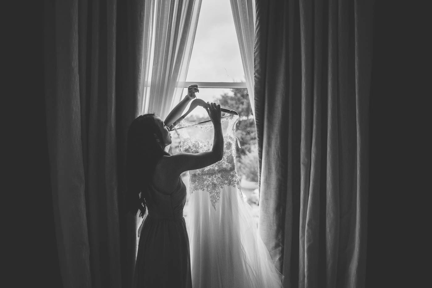 hanging the wedding gown in the window